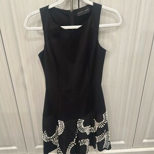 Black sleeveless Sachin + Babi dress. White pretty design on bottom.